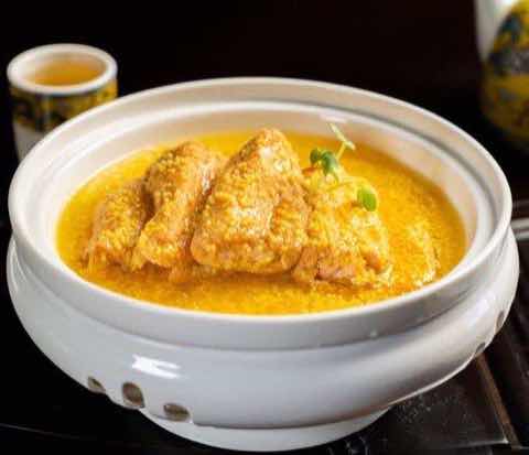 Poultry in a golden broth served in a lidded porcelain pot