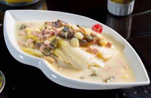 Poached fish fillet in a pale cream broth with cured ham and pickles