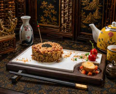 Fried rice pressed into a ring and plated on a wooden board