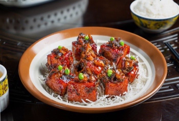 Glazed ribs set over a nest of crisp rice noodles