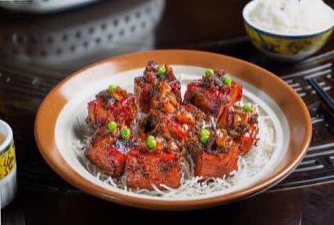 Glazed ribs set over a nest of crisp rice noodles