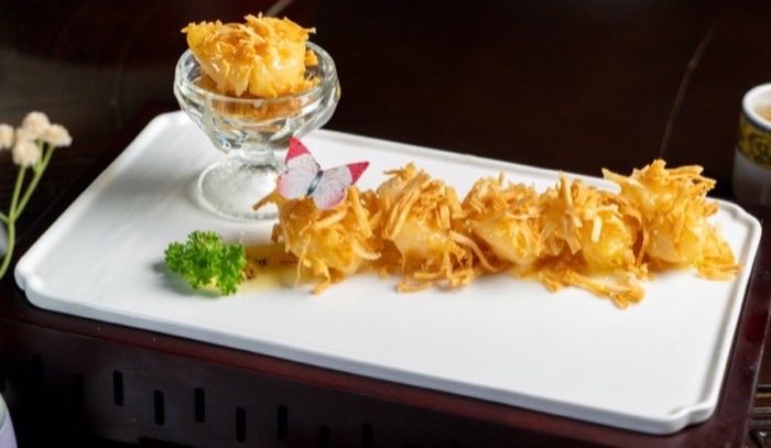 Golden crisp-wrapped morsels arranged on a long white plate