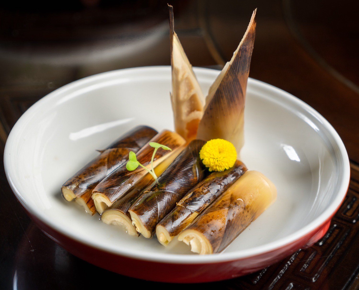 Rolled bamboo-shoot dish finished with a bamboo fan, plated at Yu by Si Jie