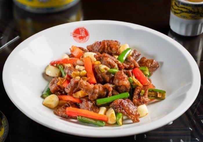 Sliced beef tossed with peppers and garlic in a dark glaze